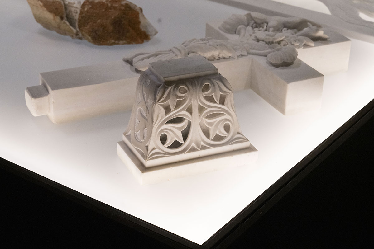 Ornately carved white marble fragment with botanical motifs, displayed under soft lighting—showcasing OnEntropy’s detail-oriented craftsmanship and historical sculptural references.